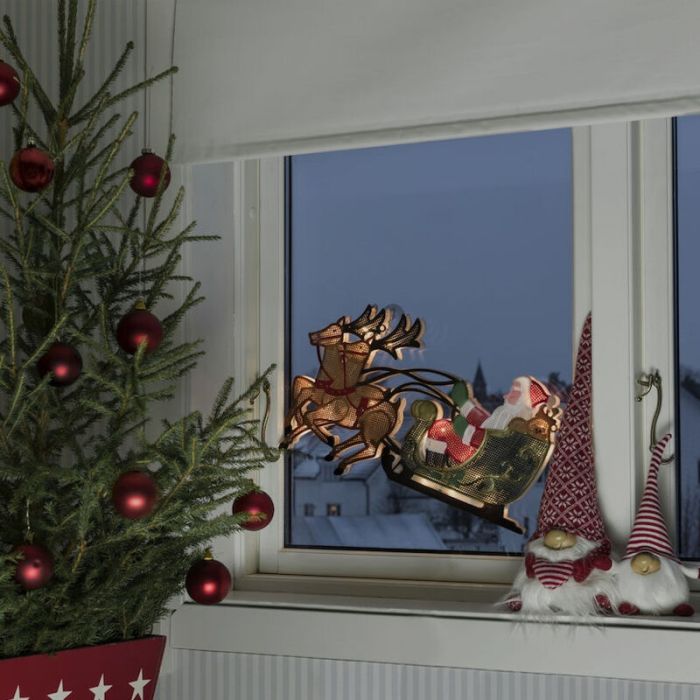 Santa con silueta de ventana de renos y trineo