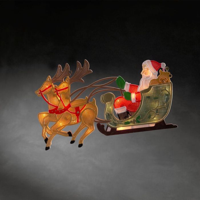 Santa con silueta de ventana de renos y trineo